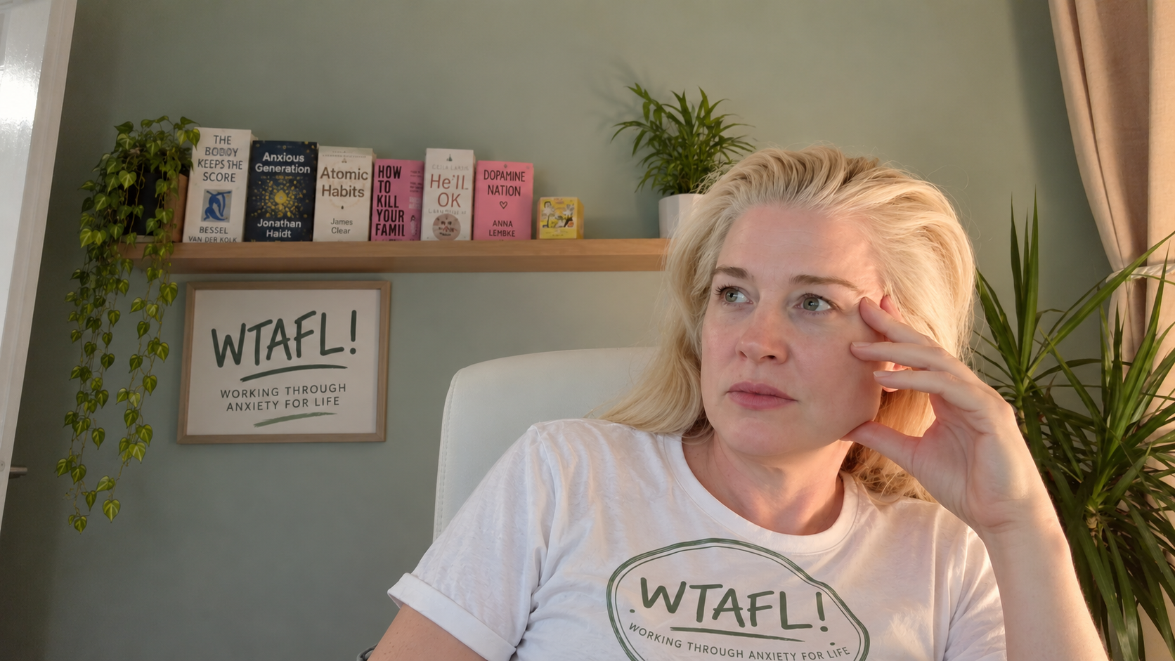 Lorraine, founder of WTAFL, by a shelf of books on anxiety and the mind